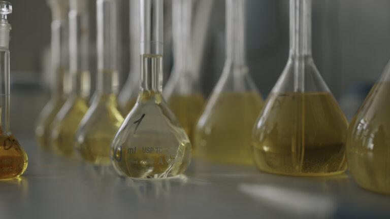 Close up of glass flasks in laboratory, equipment for elemental analysis of samples.