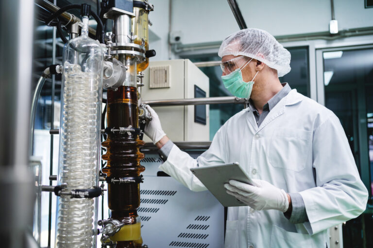 Scientists discover the use of CBD hemp oil in the laboratory. A medical or research scientist or a doctor using a test tube look at a clear solution in a laboratory or laboratory. medical cannabis